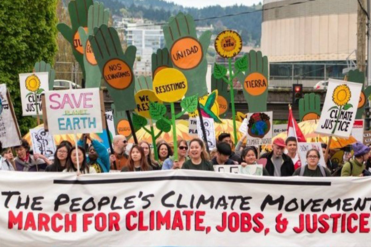 climate justice movement banner with crowd